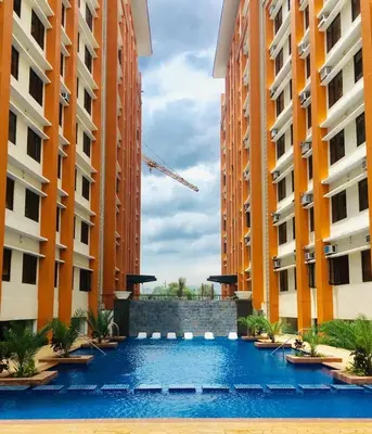 a swimming pool in between two tall buildings at Paseo Verde in Manila