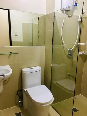 a bathroom with a toilet and a shower at Paseo Verde in Manila