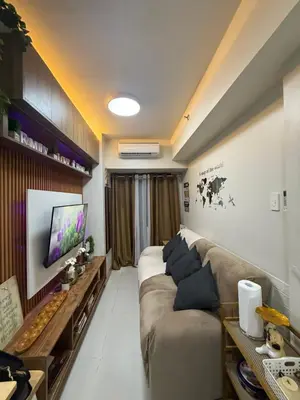 a living room with a couch and a tv at Shore Bliss Staycation by Aims in Manila