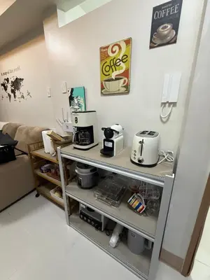 a kitchen with two coffee machines on a shelf at Shore Bliss Staycation by Aims in Manila