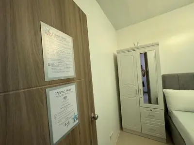 a room with a door with a sign next to a bed at RM A837 S Residence near SMX and SM Arena in Manila