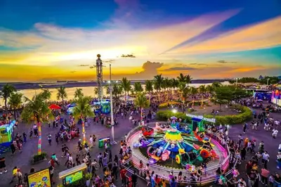 a crowd of people walking around a carnival at sunset at RM A837 S Residence near SMX and SM Arena in Manila