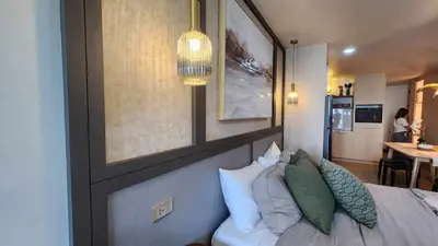 a bedroom with a bed with pillows on it at InSpire Cozy Elegance in Makati City in Manila