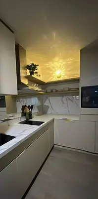 a kitchen with white counter tops and a microwave at InSpire Cozy Elegance in Makati City in Manila