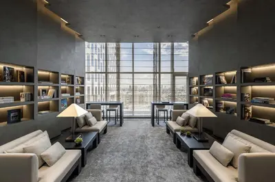 a library with couches and tables and a large window at InSpire Cozy Elegance in Makati City in Manila