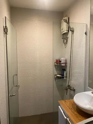 a bathroom with a shower and a sink at Affordable, Cozy & Quiet 1BR in BGC - Ideal for Short & Long Stays in Manila