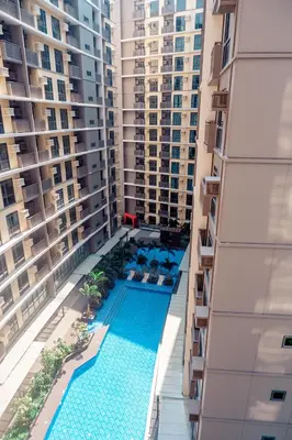 a view of the pool from the balcony of a building at Premium Condo units at Gentry Manor beside Okada Manila and near Airport in Manila