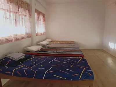 two beds in a small room with a bedvisor at Jarens Diner in Silang