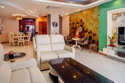a living room with white furniture and a dining room at Classic-style Top Floor In Manila Bay in Manila