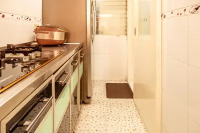 a kitchen with a stove and a sink at Classic-style Top Floor In Manila Bay in Manila