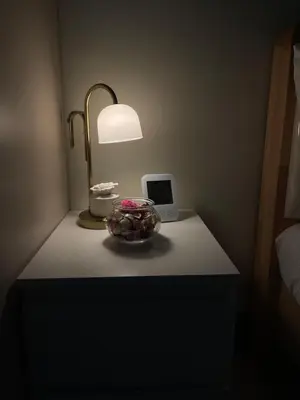 a table with a lamp and a bowl on it at Shore Residence 3 Mall of Asia by Balai Selah in Manila