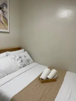 a bedroom with a bed with two pillows on it at Shore Residence 3 Mall of Asia by Balai Selah in Manila