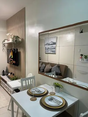 a dining room with a table and a mirror at Shore Residence 3 Mall of Asia by Balai Selah in Manila