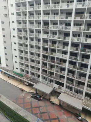 an apartment building with a parking lot in front of it at Shore Residence 3 Mall of Asia by Balai Selah in Manila