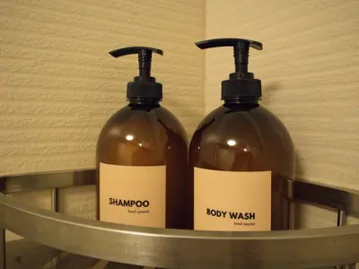 two bottles of soap in a metal shelf at Stylish & Serene Penthouse in Manila