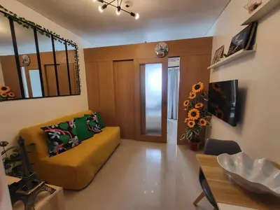 a living room with a couch and a table at Shell Residences Condo in Manila