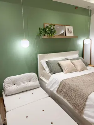a bedroom with two beds and a green wall at Top-Floor Studio in Makati with City Views Good For 2-3 Pax in Manila
