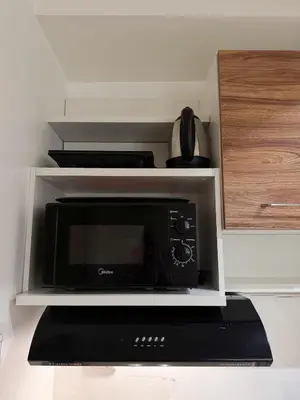 a microwave oven sitting on top of a counter at Top-Floor Studio in Makati with City Views Good For 2-3 Pax in Manila