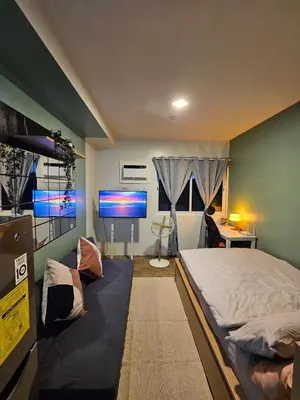a bedroom with a bed and a flat screen tv at Your Cozy Space in Stanford Suites 3 Brgy Inchican Silang Cavite in Silang