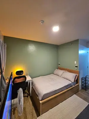 a bedroom with a bed and a table and a desk at Your Cozy Space in Stanford Suites 3 Brgy Inchican Silang Cavite in Silang