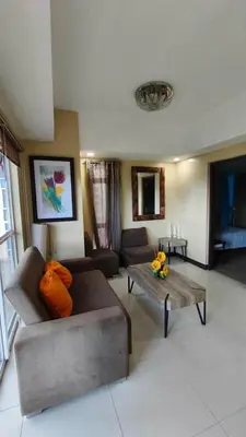 a living room with a couch and a coffee table at Venice Condotel in Manila
