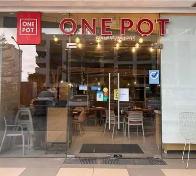 a one pot restaurant with a sign in the window at Shore Residences in Pasay Manila, near Mall of Asia and Manila Airport in Manila