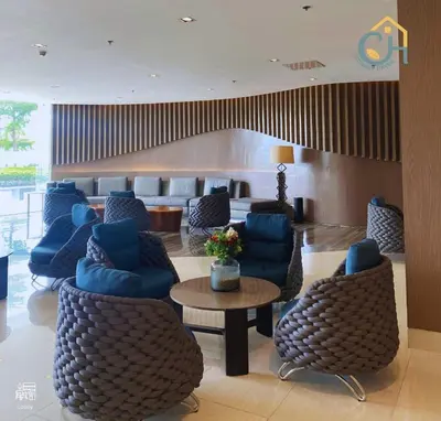 a hotel lobby with blue chairs and a table at Mall of Asia Staycation, located in Shore Residences Pasay Manila near Manila Airport in Manila