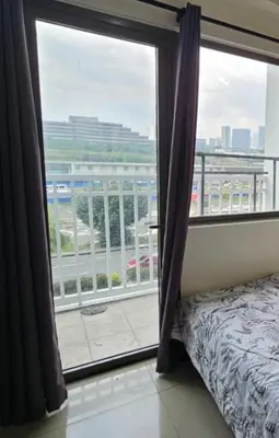 a bedroom with a window with a view of a city at Pasay Manila Condominium Rentals, walking distance to Mall of Asia and near in Manila airport, located in Shore Residences Seaside Boulevard in Manila