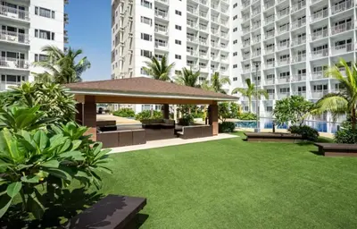 a garden with a gazebo in front of a building at Pasay Manila Condominium Rentals, walking distance to Mall of Asia and near in Manila airport, located in Shore Residences Seaside Boulevard in Manila