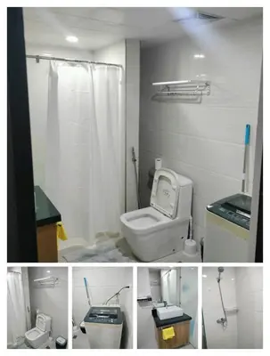 a bathroom with a white toilet and a shower at Manila Airport Accommodation for NAIA Terminal 1,2,3 in Manila