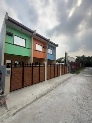 a house with a fence in front of it at Apt101 Guest House in Bacoor