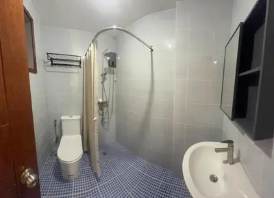 a bathroom with a toilet and a sink at Apt101 Guest House in Bacoor