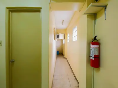 a hallway of a hospital with a fire extinguisher at Orangenest Apartelle in Sampong