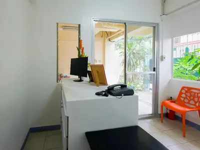 a room with a desk with a phone on it at Orangenest Apartelle in Sampong