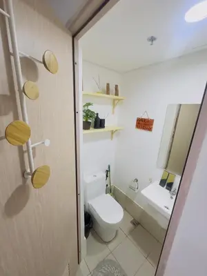 a bathroom with a toilet and a sink at Ellain's Cozy Staycation-SMDC Green 2 Residences in Dasmariñas