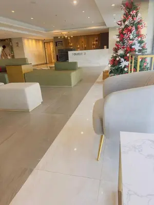a christmas tree in the middle of a lobby at Ellain's Cozy Staycation-SMDC Green 2 Residences in Dasmariñas