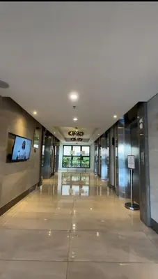 a hallway in a building with a tv on the wall at Ellain's Cozy Staycation-SMDC Green 2 Residences in Dasmariñas