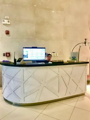 a man sitting at a desk with a computer at Manhattan Heights Tower-D Staycation in Metro Manila in Manila