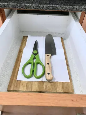 a pair of scissors and a knife on a cutting board at Manhattan Heights Tower-D Staycation in Metro Manila in Manila