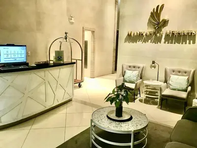 a living room with a couch and chairs and a table at Manhattan Heights Tower-D Staycation in Metro Manila in Manila