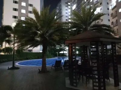 a gazebo and palm trees in a courtyard at Condo with Sunset View in Manila