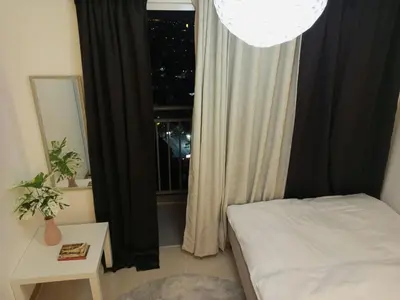 a bedroom with a bed and a window at Condo with Sunset View in Manila