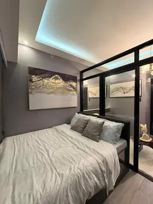 a bedroom with a large white bed with a window at Cozy Escape with Golden Hour View Condo in Manila