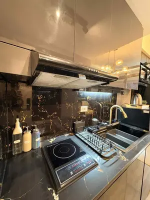 a kitchen with a stove top oven in a kitchen at Cozy Escape with Golden Hour View Condo in Manila