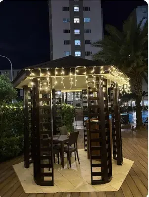 a gazebo with lights and a table and chairs at Stunning Pool and City View in Manila