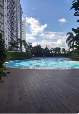 a swimming pool with blue water in a resort at Stunning Pool and City View in Manila