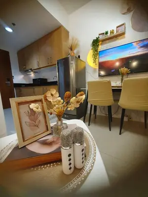 a kitchen with a table and a dining room at Sea Residences Golden escape condotel in Manila
