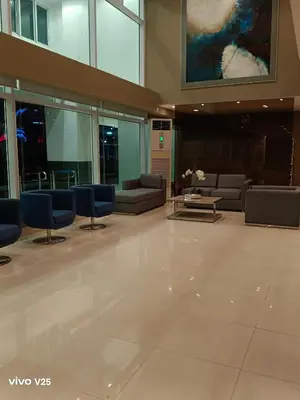 a lobby with chairs and couches in a building at Sea Residences Golden escape condotel in Manila
