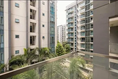 a balcony with palm trees and tall buildings at 1 Bedroom Apartment Condo Across Manila Airport NAIA T3 in Manila