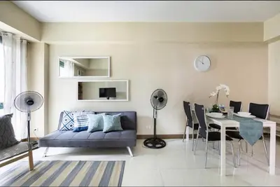 a living room with a couch and a table at 1 Bedroom Apartment Condo Across Manila Airport NAIA T3 in Manila